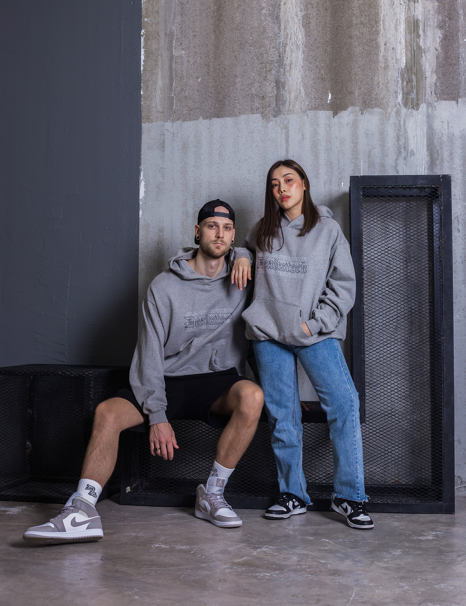 A Male and female model wearing Deadstock Clo All or Nothing Hoodie Heather Grey 