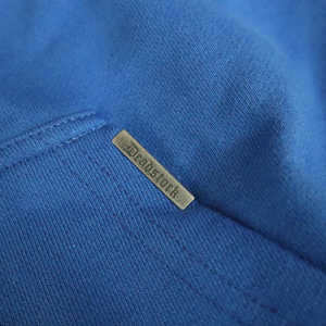 Deadstock clo metal tag on cobalt blue hoodie