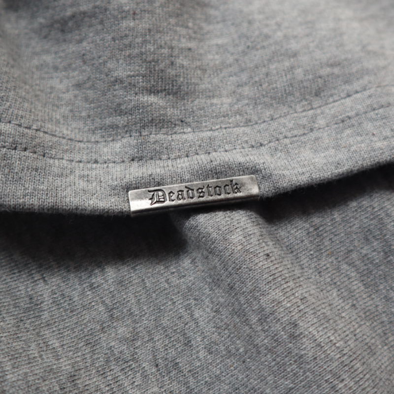 Deadstock Clo metal tag on oversized heather grey tshirt