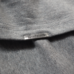 Load image into Gallery viewer, Deadstock Clo metal tag on oversized heather grey tshirt
